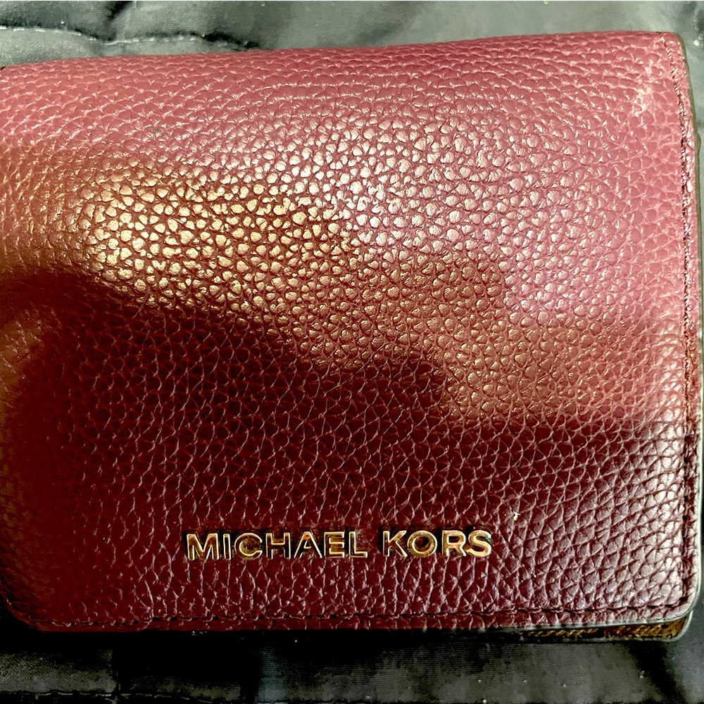 Michael Kors burgundy folding wallet.